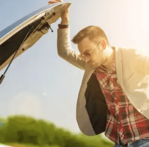 Free car removal in Melbourne for a driver checking a damaged vehicle under the open bonnet