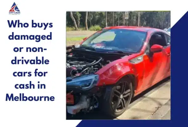 Red damaged sports coupe with missing front bumper and exposed engine parked roadside.