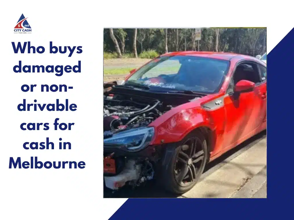 Red damaged sports coupe with missing front bumper and exposed engine parked roadside.